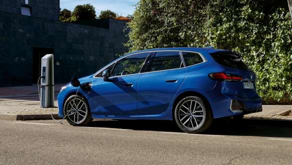 BMW 2 Series Active Tourer 230e plug-in hybrid U06 2021 parking at charging station BMW 2 Series Active Tourer 230e plug-in hybrid U06 2021 M Portimao Blue metallic side view parking at charging station
