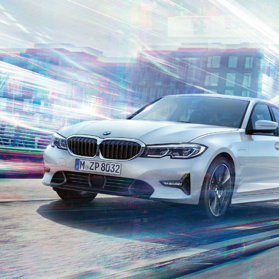 BMW 3 Series Sedan, driving 330e. BMW 3 Series Sedan 330e driving against an urban backround.
