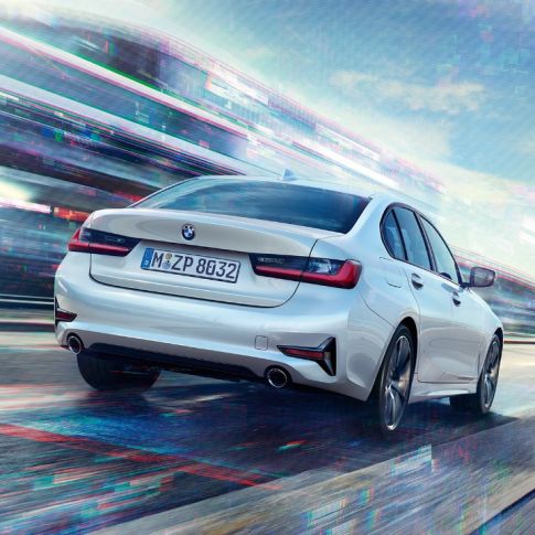 BMW 3 Series Sedan, 330e rear view. Three-quarter rear view of the driving BMW 3 Series Sedan 330e.