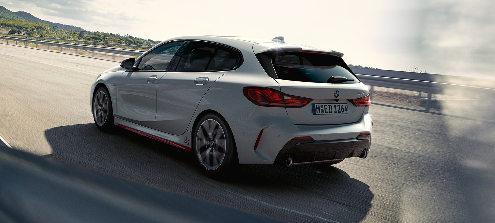 BMW 1 Series 128ti F40, three-quarter rear view driving 