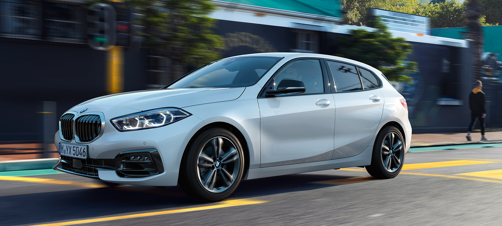 BMW 1 Series F40 Model Sport Line in Mineral White metallic, three-quarter side view, driving