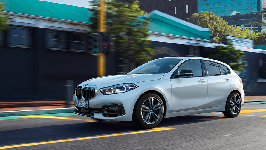 BMW 1 Series (F40) Three-quarter side view driving against an urban backdrop BMW 1 Series (F40) Three-quarter side view driving against an urban backdrop