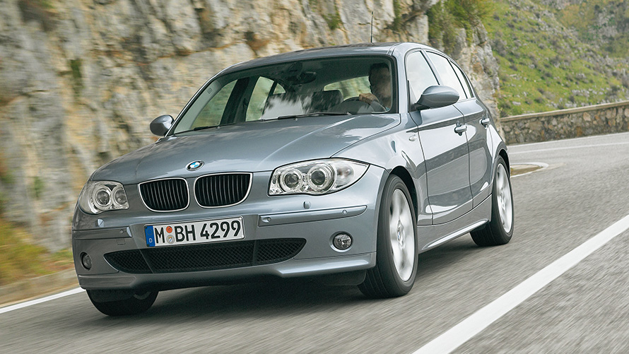 BMW 1 Series (E87) Three-quarter front view driving in front of hill BMW 1 Series (E87) Three-quarter front view driving in front of hill