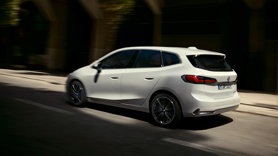 BMW 2 Series Active Tourer U06 2021 side view BMW 2 Series Active Tourer U06 2021 Mineral White metallic driving on the street side view