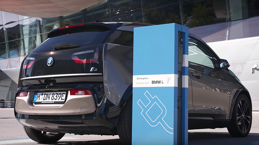 BMW i3 on charging station BMW 5 Series Sedan G30 BMW i3 on charging station three-quarter rear view