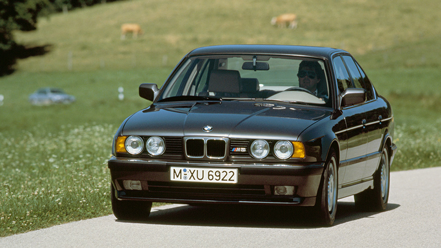 BMW M Sedan (E34) three-quarter front view driving BMW M Sedan (E34) three-quarter front view driving