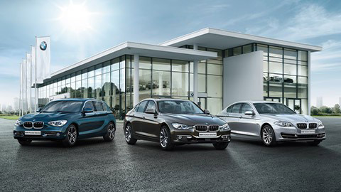 BMW used cars in front of BMW dealership