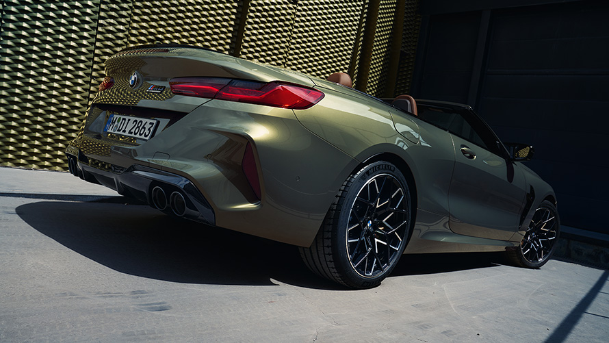 BMW M8 Competition Convertible F91 LCI Facelift 2022 BMW Individual Brass metallic three-quarter rear view low angle shot