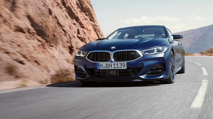 three-quarter front view driving BMW 8 Series Gran Coupé M850i xDrive 2022 G16 LCI Facelift BMW 8 Series Gran Coupé M850i xDrive 2022 G16 LCI Facelift BMW Individual Frozen Tansanit Blue metallic three-quarter front view driving