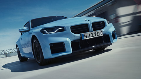 BMW M Series BMW M2 G87 front view driving on the street BMW M2 G87 front view driving on the street