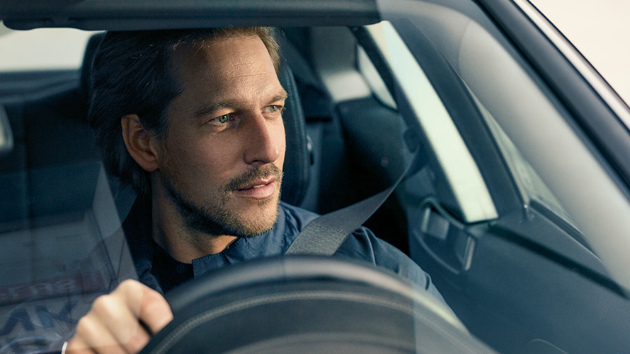 Man driving BMW Man driving BMW looking through windshield