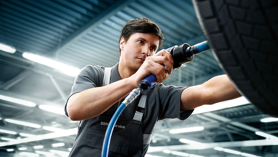 BMW offers wheels service BMW offers summer wheels service BMW service employee repairing a BMW