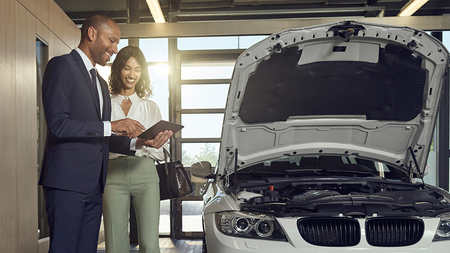 Check and maintenance BMW Service customer and BMW Service employees discuss check and maintenance