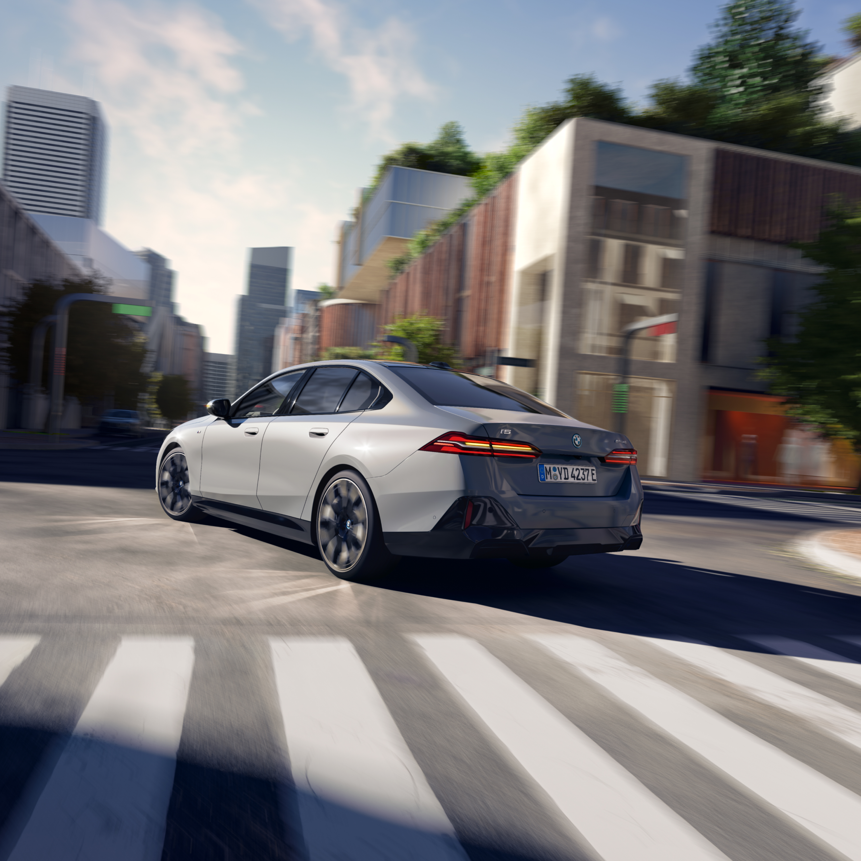 Rear view of a grey BMW i5 on a city road